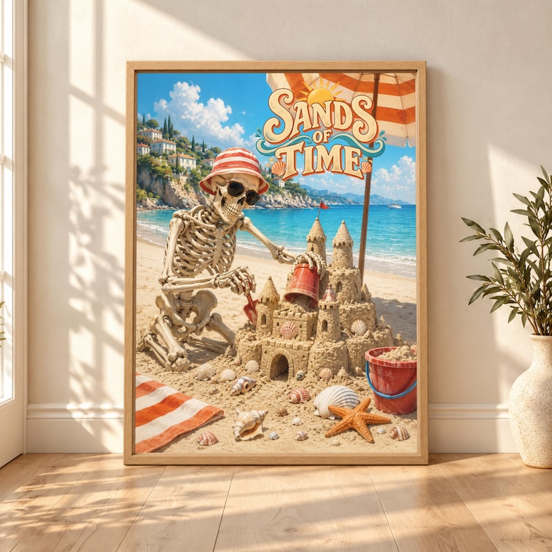 Framed Sands of Time skeleton wall art showing a skeleton in sunglasses and a striped sun hat building an elaborate sandcastle on a sunny turquoise Mediterranean beach.