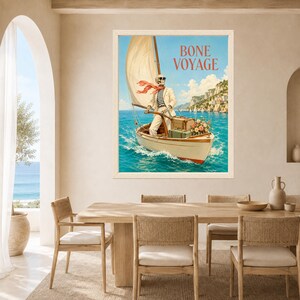 May include: A framed wall art print featuring a skeleton wearing a striped shirt, blazer, and red scarf, steering a sailboat on blue water. The skeleton wears sunglasses and carries luggage. The text BONE VOYAGE is printed in red at the top.
