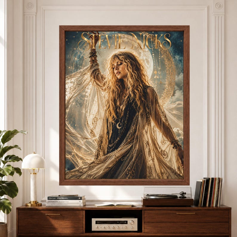 Framed Stevie Nicks wall art showing a female rock singer in flowing black and cream lace beneath a large glowing moon, surrounded by stars, clouds and ornate golden celestial details.