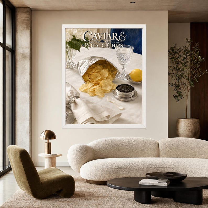 May include: A framed wall art print titled Caviar & Potato Chips featuring a silver foil bag of golden potato chips, a small silver tin of black caviar, a crystal glass, a lemon, and a white cloth napkin with a silver napkin ring on a table.