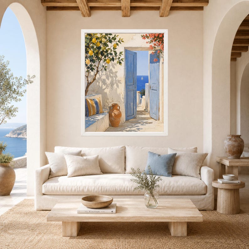 May include: A framed wall art print depicting a Mediterranean scene with an open blue door, a terracotta vase, and a lemon tree. The artwork features a view of the sea through the doorway, with warm sunlight casting shadows on the wall.