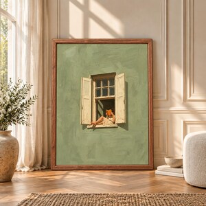 Framed sage green wall art showing a barefoot woman sitting in an open cream window while reading an orange book against a textured minimalist green wall.