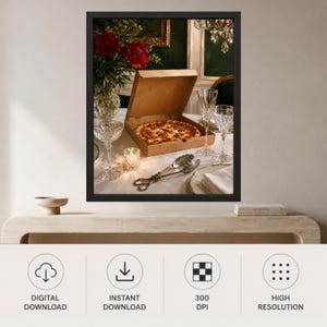 May include: A framed wall art print featuring a pizza in a cardboard box on a table set with crystal glassware, a small lit candle, silver serving tongs, and a vase of red flowers. The scene is captured in a dark, moody interior setting.
