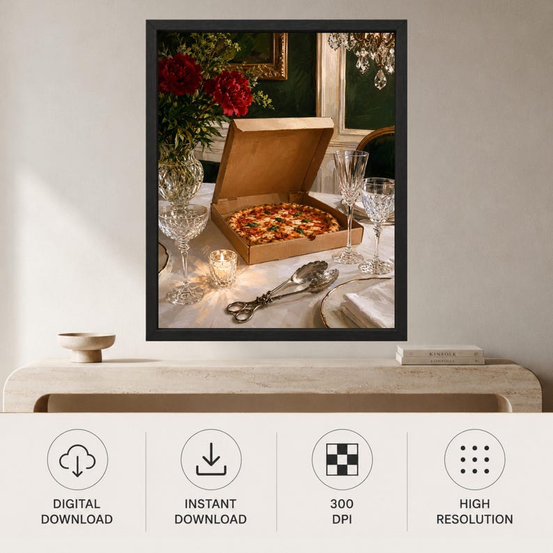 May include: A framed wall art print featuring a pizza in a cardboard box on a table set with crystal glassware, a small lit candle, silver serving tongs, and a vase of red flowers. The scene is captured in a dark, moody interior setting.