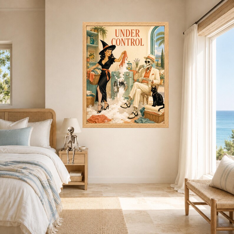 May include: A framed wall art print titled UNDER CONTROL featuring a vintage-style illustration of a person in a witch hat doing laundry with a skeleton in a suit and hat, a black cat, and soap suds overflowing from a washing machine.