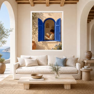 May include: A framed wall art print depicting an arched window with vibrant blue shutters set into a beige stucco wall. Through the open window, a person is visible sitting and reading a book. The scene is bathed in warm, natural sunlight.