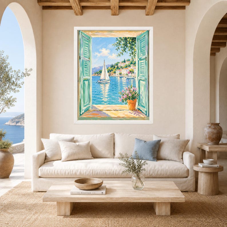 May include: A framed wall art print depicting an open window view of a Mediterranean coastal scene. The painting features turquoise shutters, a white sailboat on blue water, a hillside village, and a terracotta pot with pink flowers on the sill.