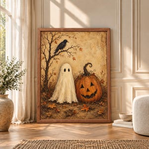 Framed vintage Halloween wall art showing a cream sheet ghost beside a large orange jack-o-lantern with a black crow perched in an autumn tree on a textured aged background.