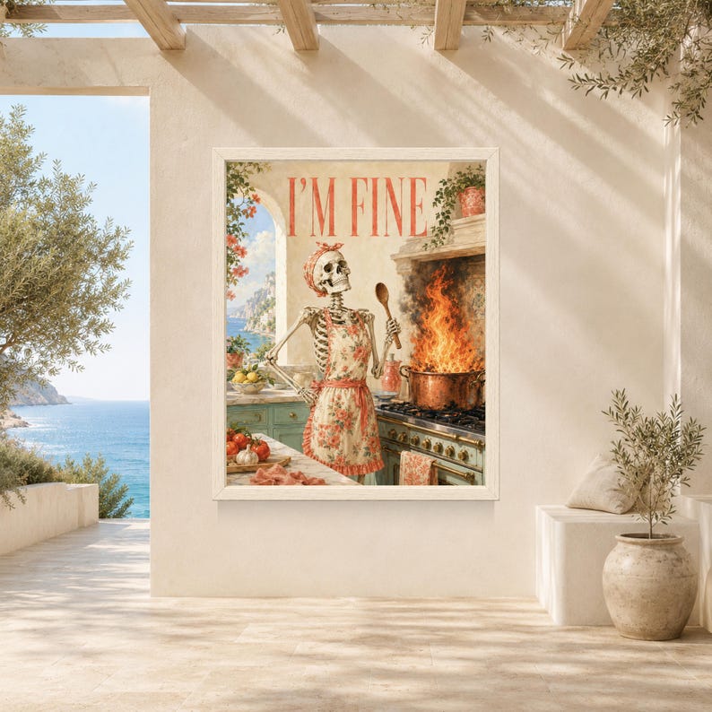 May include: A framed wall art print featuring a skeleton wearing a floral apron and headscarf, standing in a kitchen. The skeleton holds a wooden spoon near a pot with large flames on a stove. The text I'M FINE is printed in red at the top.