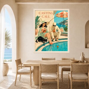 May include: A framed wall art print titled CASTING CALL featuring a woman in a wide-brimmed hat and a skeleton in a suit sitting by a swimming pool. A black cat sits nearby, and the skeleton holds a fishing rod with a small pumpkin on the line.