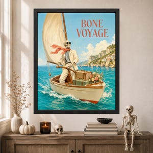 May include: A framed wall art print titled BONE VOYAGE featuring a skeleton wearing sunglasses, a white blazer, and a striped shirt, steering a sailboat on blue water. The boat carries vintage luggage and flowers near a coastal cliffside.