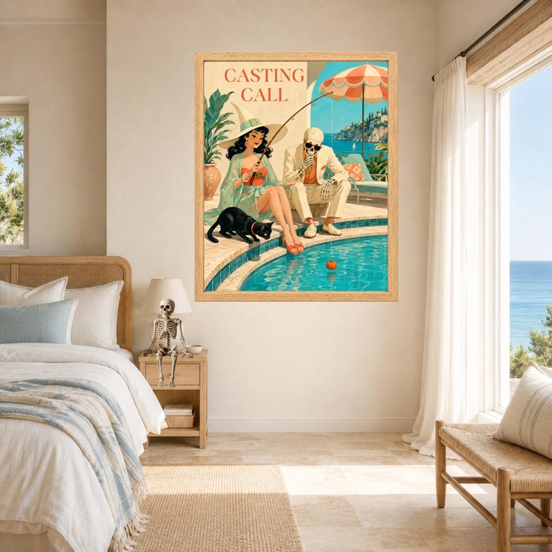 May include: A framed wall art print titled CASTING CALL featuring a woman in a wide-brimmed hat and a skeleton in a suit sitting by a swimming pool. The woman holds a fishing rod with a pumpkin on the line, while a black cat sits nearby.