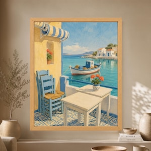 Framed Mediterranean wall art showing a Greek-style seaside taverna terrace with blue chairs, yellow walls, patterned tiles, red flowers and a fishing boat floating in a turquoise harbor.
