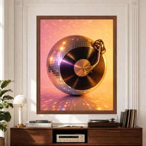Framed disco music wall art featuring a mirrored disco ball combined with a glossy black vinyl record and gold turntable tonearm, illuminated by warm pink, peach, purple and golden reflections.