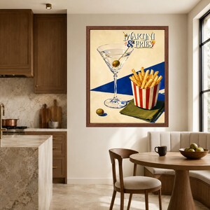 May include: A framed wall art print titled Martini & Fries featuring a martini glass with an olive, a red and white striped container of golden french fries, and a green napkin, set against a cream and blue geometric background.