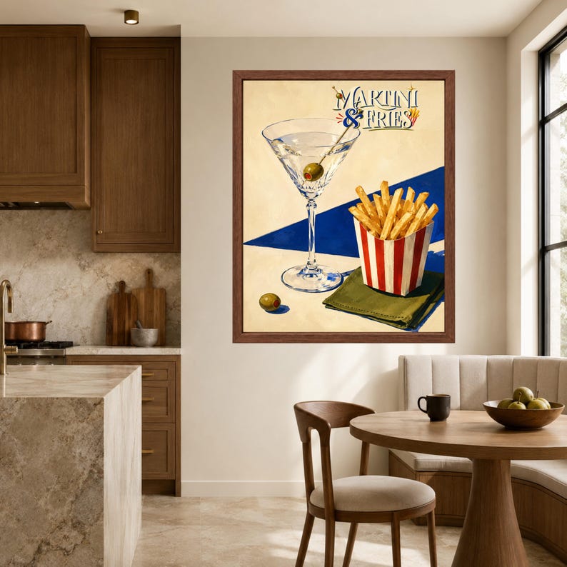 May include: A framed wall art print titled Martini & Fries featuring a martini glass with an olive, a red and white striped container of golden french fries, and a green napkin, set against a cream and blue geometric background.