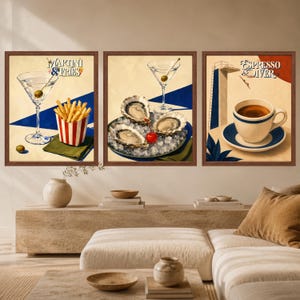 May include: A set of three framed wall art prints. The first shows a martini glass with an olive and a carton of fries with the text Martini & Fries. The second shows oysters on ice and a martini glass. The third shows a coffee cup with the text Espresso Diver.