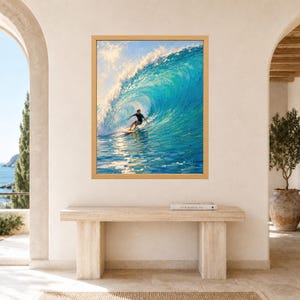 May include: A framed wall art print depicting a surfer riding a large, curling turquoise ocean wave. The painting features vibrant blue and white tones with visible brushstrokes, capturing the movement of water and sunlight reflecting on the surface.