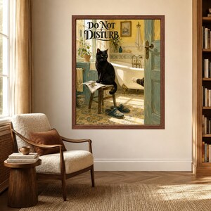 May include: A framed wall art print featuring a black cat sitting on a wooden stool in a bathroom, reading a newspaper. The text "DO NOT DISTURB" is printed at the top. A white clawfoot bathtub, blue door, and blue slippers are visible.