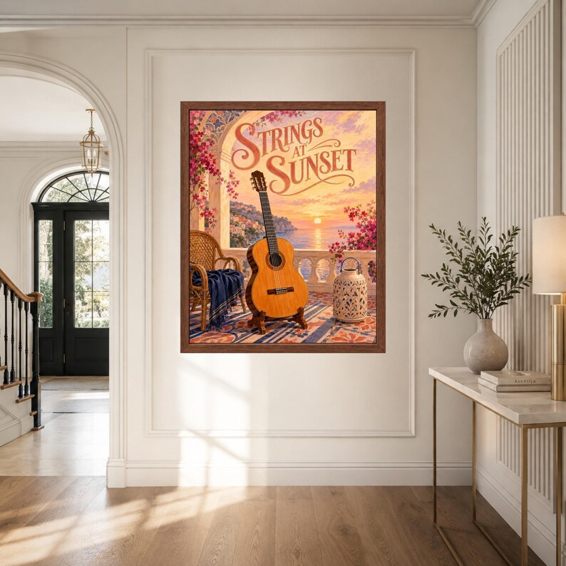 May include: A framed wall art print titled Strings at Sunset featuring a classical guitar on a stand, a wicker chair with a blue throw, and a decorative lantern on a balcony overlooking a coastal sunset with pink flowers and a stone archway.