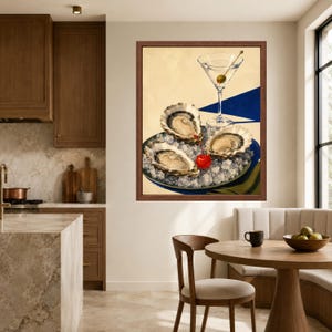 May include: A framed wall art print featuring three raw oysters served on a bed of crushed ice on a plate, accompanied by a martini glass containing a single green olive and a bright red cherry, set against a cream and blue background.