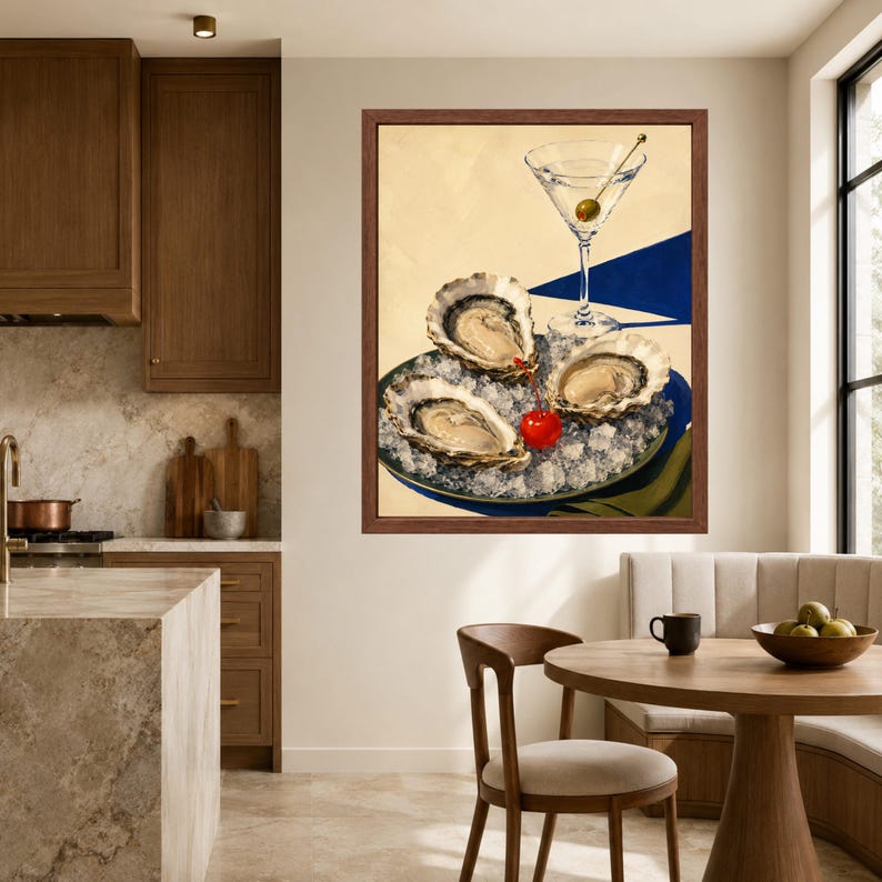 May include: A framed wall art print featuring three raw oysters served on a bed of crushed ice on a plate, accompanied by a martini glass containing a single green olive and a bright red cherry, set against a cream and blue background.
