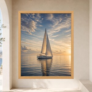 May include: A framed wall art print featuring a white sailboat on calm water during a golden sunset. The sky is filled with soft, wispy clouds reflecting warm orange and blue hues. The sailboat is centered, casting a clear reflection below.