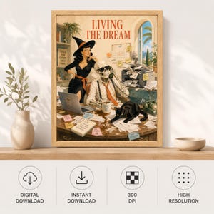 May include: A framed wall art print titled LIVING THE DREAM featuring a witch in a black dress and hat standing beside a skeleton wearing a tie and sunglasses at a desk. A black cat sits on a cluttered desk with a laptop, phone, and papers.