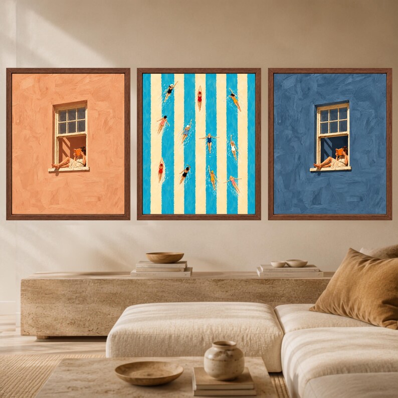 May include: A set of three framed wall art prints. The left print shows a person reading in a window against a peach wall. The center print features swimmers in a pool with blue and white stripes. The right print shows a person reading in a window against a blue wall.