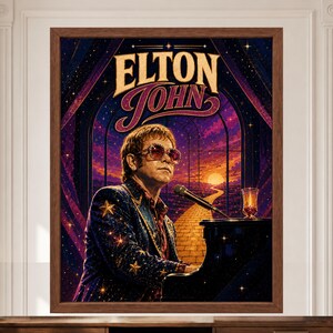 May include: A framed wall art print featuring a stylized illustration of Elton John wearing star-patterned clothing and sunglasses while playing a piano. The background depicts a yellow brick road leading toward a sunset under a starry night sky.