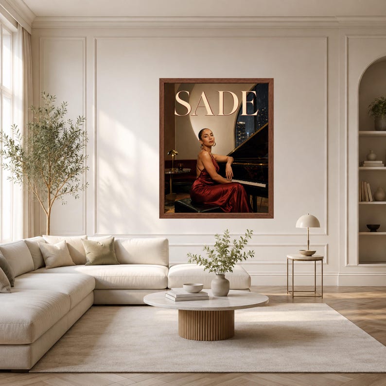 May include: A framed wall art print featuring a portrait of a person in a dark red satin dress sitting at a black grand piano. The word SADE is printed in large, light-colored capital letters at the top of the image against a dark background.