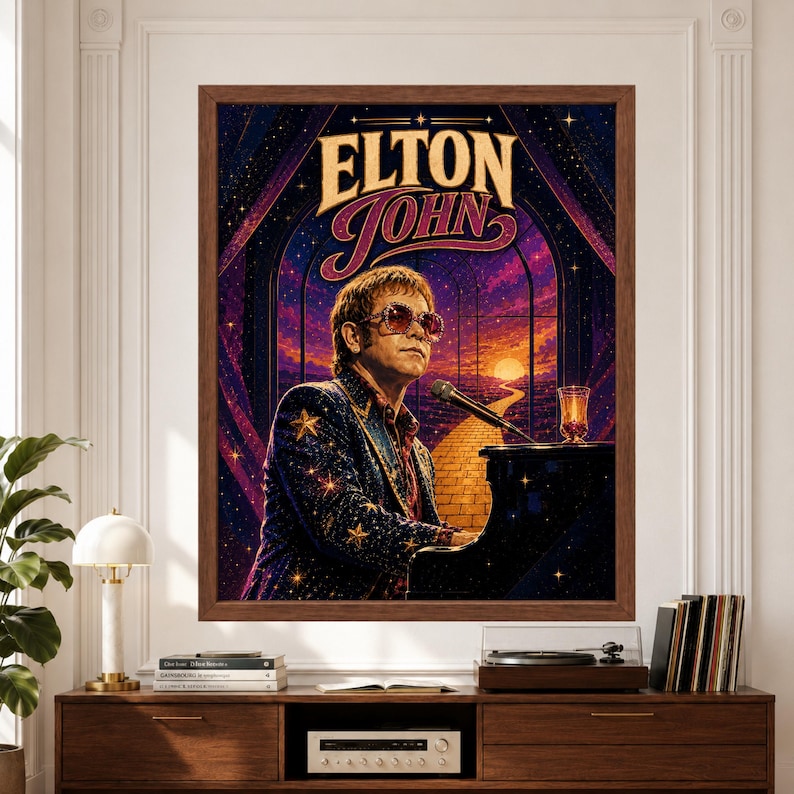 Framed Elton John wall art featuring the singer at a black grand piano wearing oversized glasses and a star-covered jacket in a purple celestial scene with golden stars, sunset and winding road.