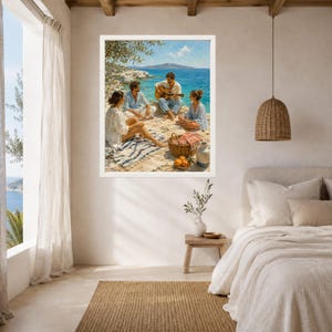 May include: A framed wall art print depicting three people sitting on a rocky beach by the turquoise sea. One person plays an acoustic guitar while others relax on a striped blanket near a picnic basket with oranges and a ceramic jug.