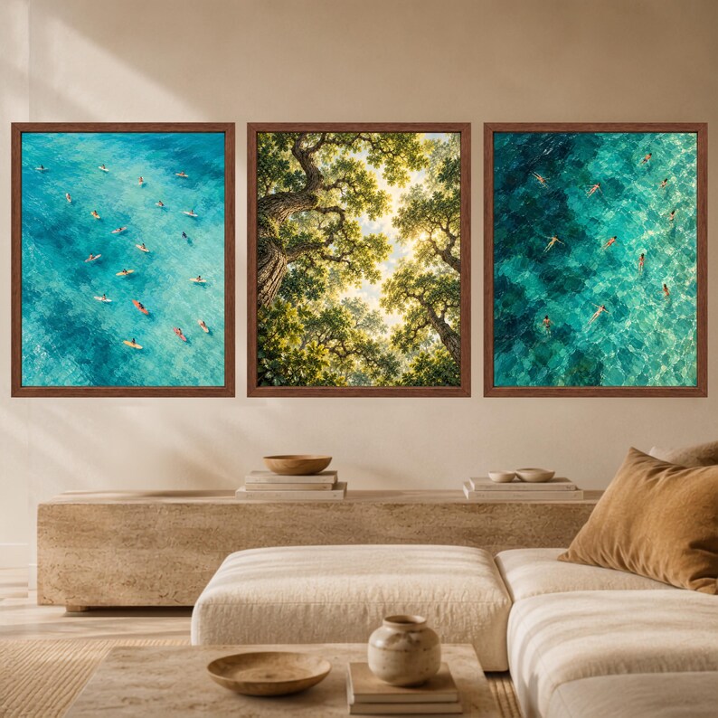 May include: A set of three square wall art prints in brown frames. The left print shows an aerial view of surfers on blue water. The center print displays a low-angle view of green tree canopies. The right print features an aerial view of swimmers.