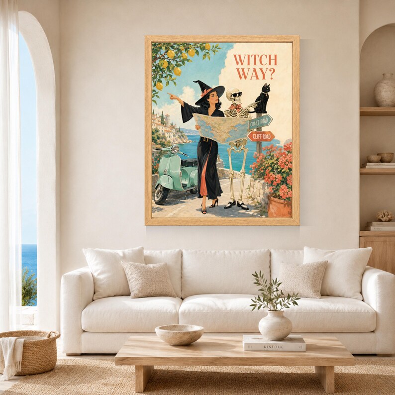 Puede incluir: Una l&aacute;mina de arte enmarcada titulada WITCH WAY? que muestra a una bruja con vestido negro y un esqueleto con gafas de sol junto a un scooter verde claro. Sostienen un mapa ante una se&ntilde;al hacia Coast Road y Cliff Road con un gato negro.