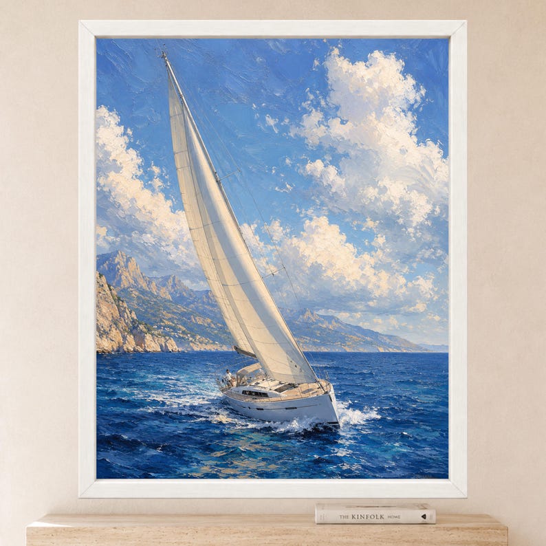 May include: A framed oil painting depicting a white sailboat with a large sail navigating deep blue ocean waters. The scene features a bright blue sky filled with fluffy white clouds and a rugged, mountainous coastline in the background.