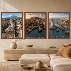 May include: Three framed wall art prints depicting historical cityscapes. The left print shows Pompeii 79 CE, the center print shows Carthage 220 BCE, and the right print shows Alexandria 220 BCE. Each print features a brown frame and detailed scenes.