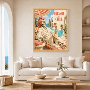 May include: A framed wall art print featuring a skeleton wearing a beige bathrobe, a coral towel wrap, and cucumber slices over its eyes. The skeleton reclines on a lounge chair by a pool, holding a cocktail, with the text DRESSED TO CHILL.
