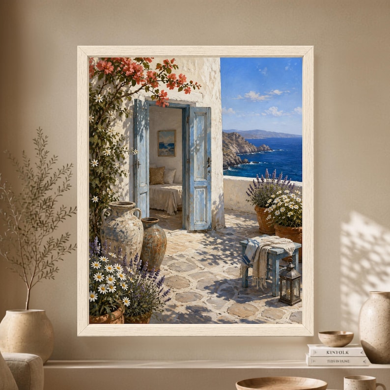 Framed Greek island wall art showing weathered blue doors in a whitewashed seaside house with bougainvillea, lavender, daisies, stone paving and a deep blue Mediterranean sea view.