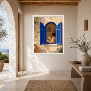 May include: A framed wall art print depicting an arched window with vibrant blue shutters set into a beige stucco wall. Inside the window, a person sits reading a book. The scene includes an olive tree in a terracotta pot and blue flowers.