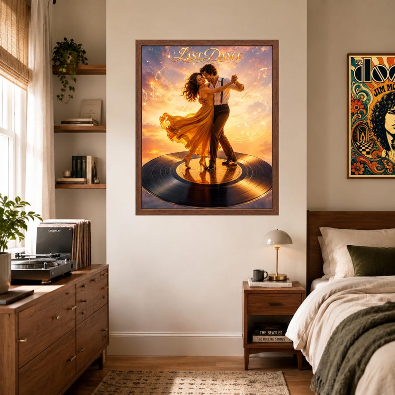 May include: A framed wall art print titled Last Dance featuring a couple dancing on a large black vinyl record against a golden sunset sky. The person on the left wears a flowing yellow dress, and the person on the right wears a white shirt and dark trousers.
