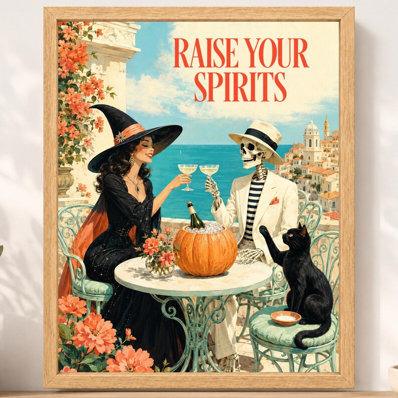 May include: A framed art print featuring a witch in a black dress and a skeleton in a white suit sitting at a table with a pumpkin, clinking glasses. The text RAISE YOUR SPIRITS is at the top. A black cat sits on a chair near a coastal town.