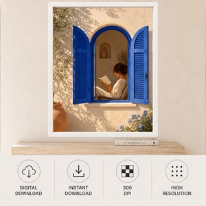 May include: A framed wall art print featuring an arched window with vibrant blue shutters set into a beige stucco wall. A person sits inside the window reading a book. To the left is a terracotta pot with a small tree and blue flowers below.