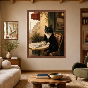 May include: A framed wall art print depicting a black and white cat sitting on a wicker chair at a small round table with a coffee cup and newspaper, set against a Parisian street scene featuring the Eiffel Tower in the background.