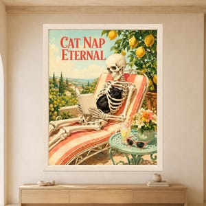 Framed Cat Nap Eternal wall art showing a skeleton reading on a coral striped sun lounger with a sleeping black cat curled inside its ribcage beneath a lemon tree on a sunny Mediterranean terrace.