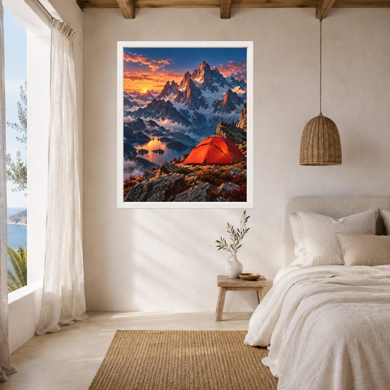 May include: A rectangular wall art print featuring a vibrant landscape of snow-capped mountain peaks at sunset. A bright orange tent sits on a rocky foreground overlooking a calm lake reflecting the golden light of the sky and clouds.