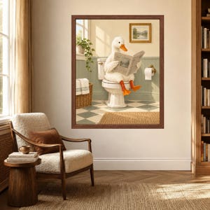 May include: A framed wall art print depicting a white duck with orange feet sitting on a white toilet in a bathroom, reading a newspaper. The bathroom features green wainscoting, a checkered floor, a wicker basket, and a small framed landscape painting.
