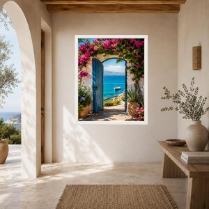 May include: A framed wall art print depicting an open blue door leading to a Mediterranean coastal scene. The doorway is framed by vibrant pink bougainvillea flowers, with a small white boat visible on the blue sea under a clear sky.