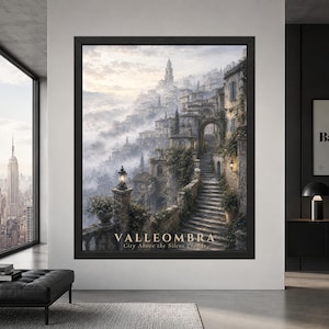 Framed Valleombra fantasy city wall art showing a mist-covered mountain village with old stone stairways, arched passages, ivy-covered buildings, lanterns and a hilltop tower above the clouds.