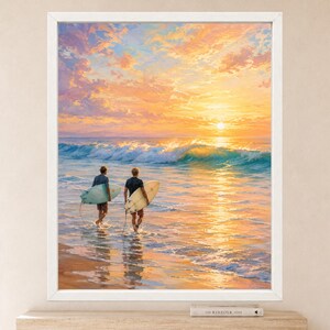 May include: A framed wall art print depicting two individuals carrying surfboards while walking into the ocean at sunset. The scene features a vibrant orange and yellow sky, a breaking turquoise wave, and golden reflections on the wet sand.